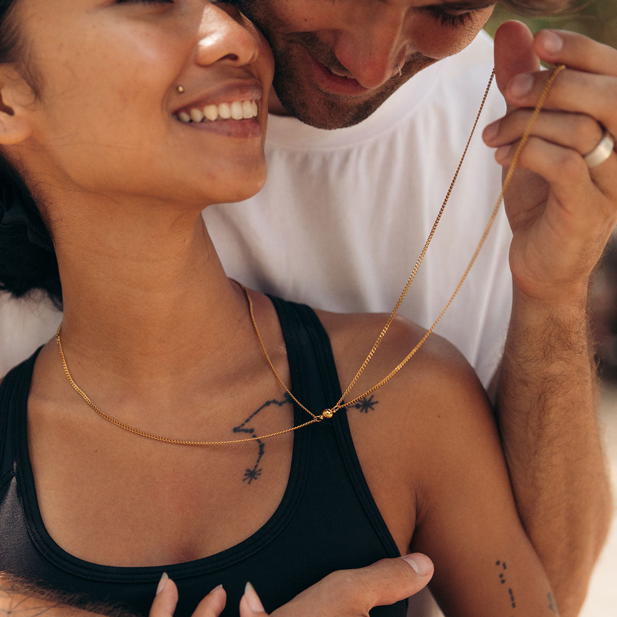 Couple wearing magnetic necklaces