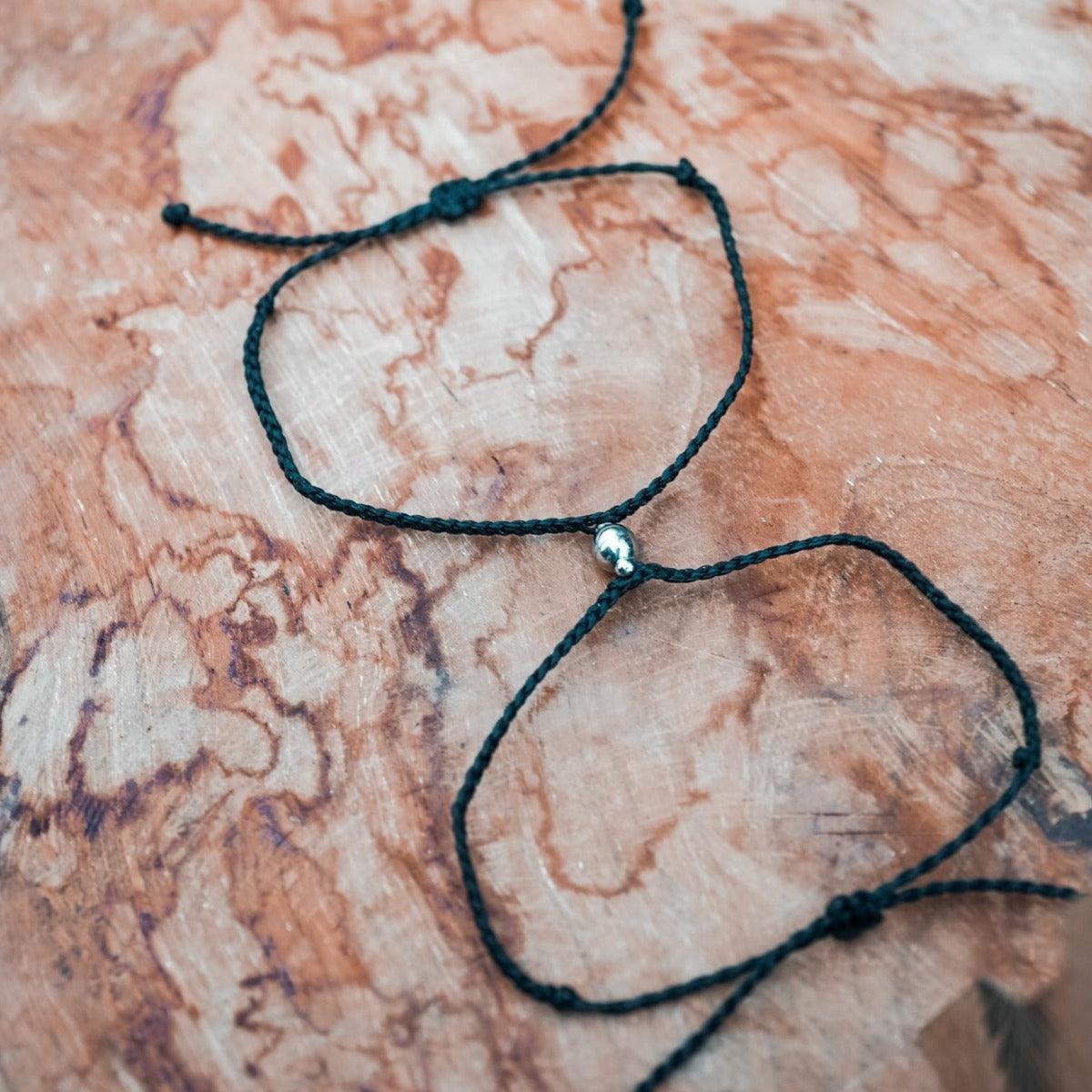 Magnetic bracelets in black on beach rock