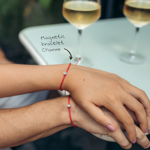 A couple wearing magnetic bracelets in red