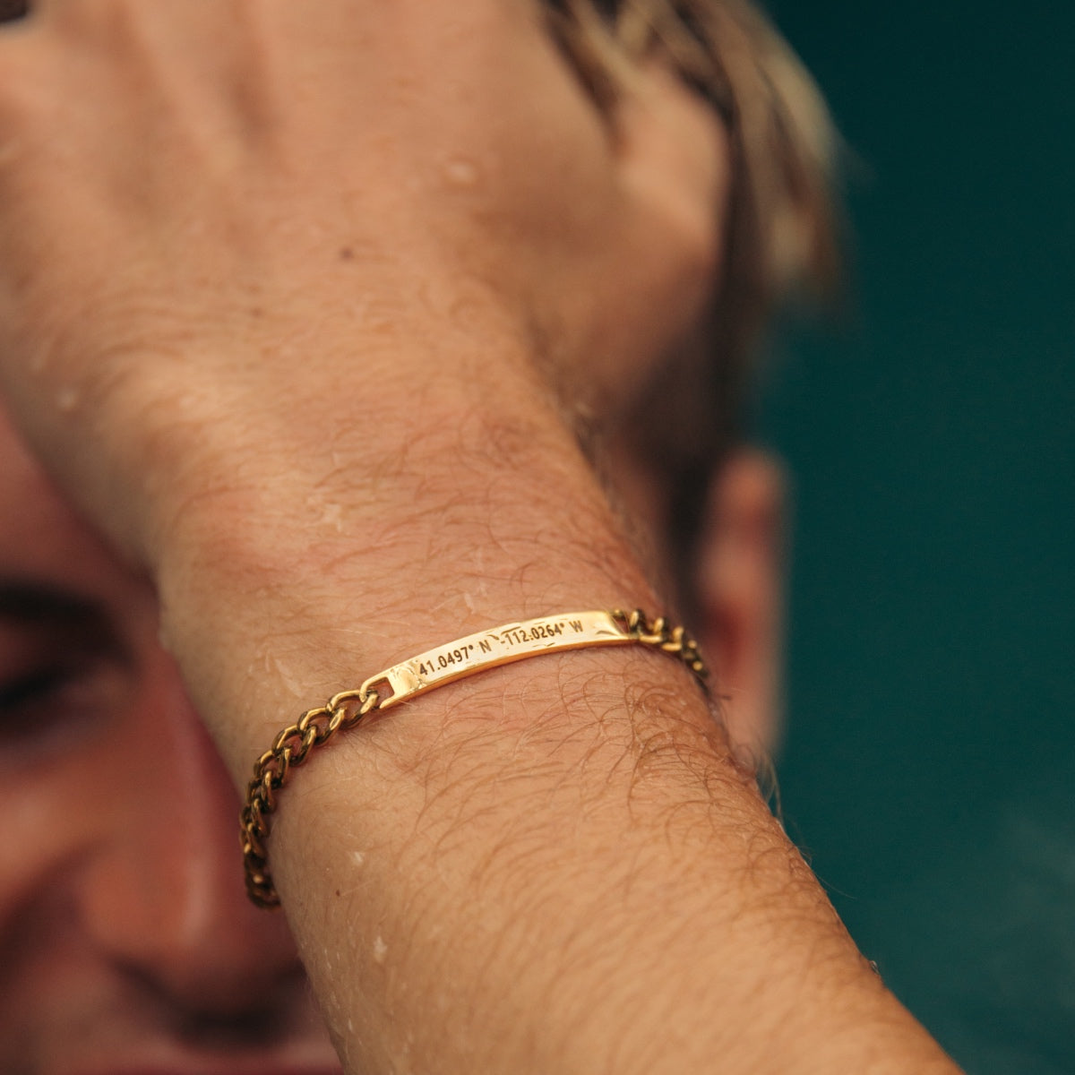 A man wearing a bracelet personalized in gold