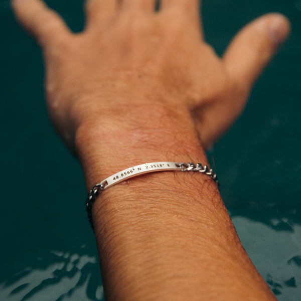 A man wearing a bracelet personalized in silver