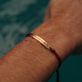 Red thread bracelet with gold bar