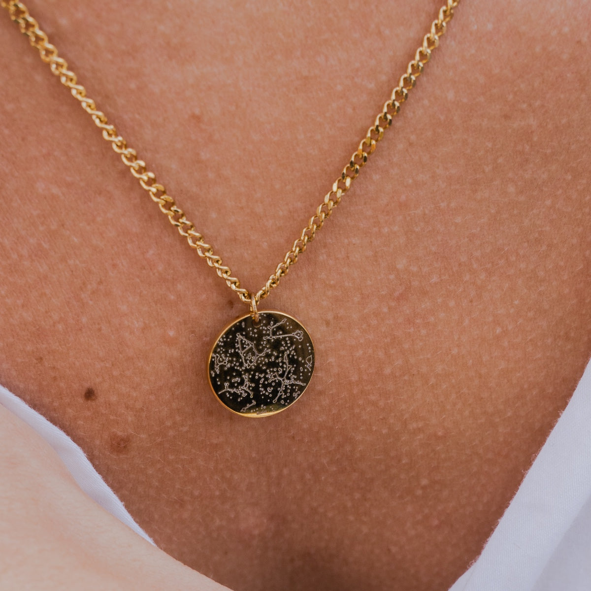 Necklace with a star map in gold