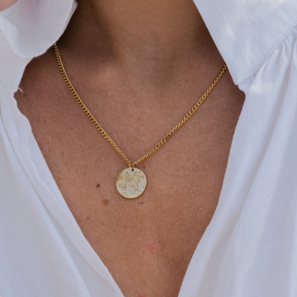 Necklace with a star constellation worn with a white shirt
