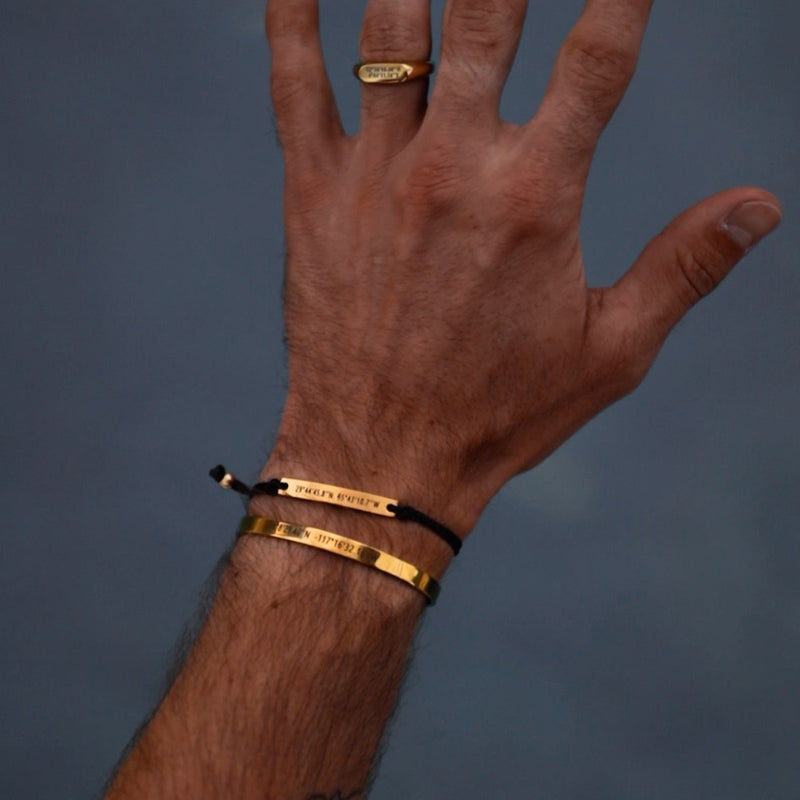 A man wearing two customizable bracelets